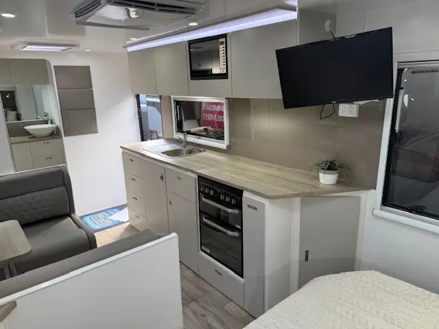 Café seating and kitchen inside the Cruiser 216R